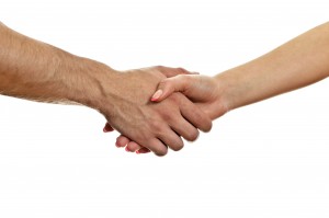 Man and woman shaking hands. Isolated on white.